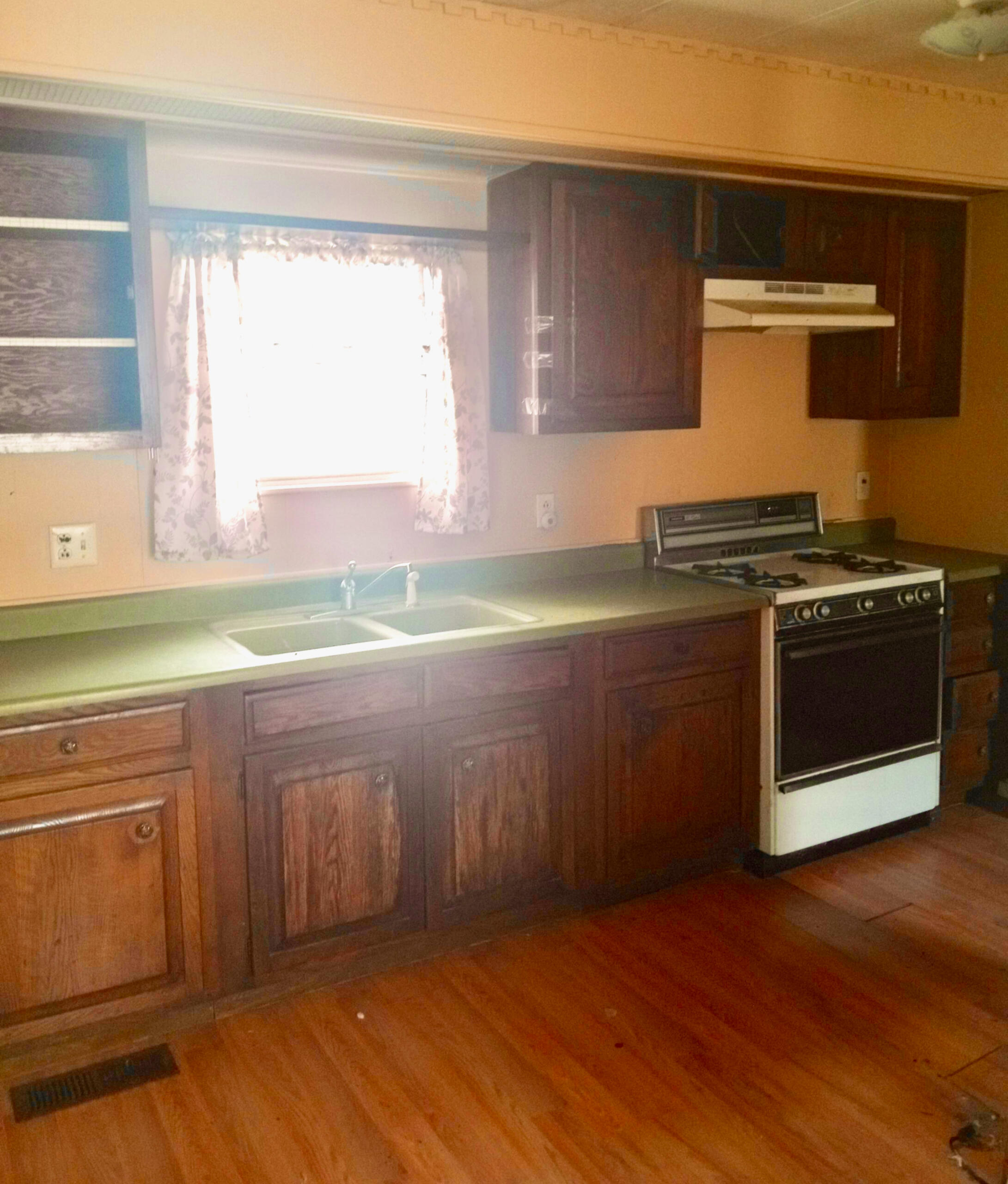 Before pic of a full cabinet repaint and total kitchen restoration